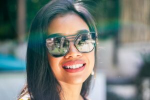 woman smiling in sunglasses